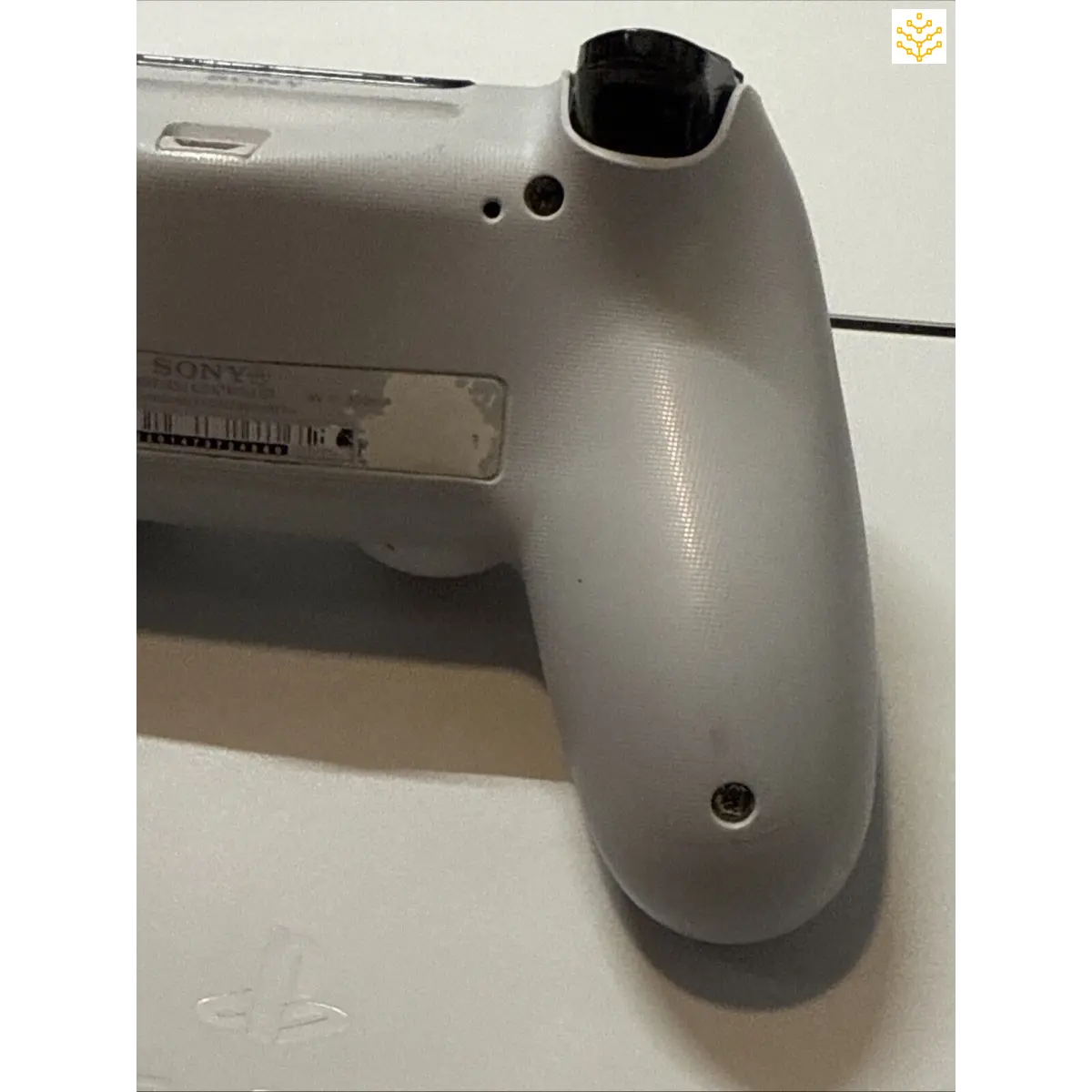 Gray plastic handle or grip portion of an electronic device or controller.