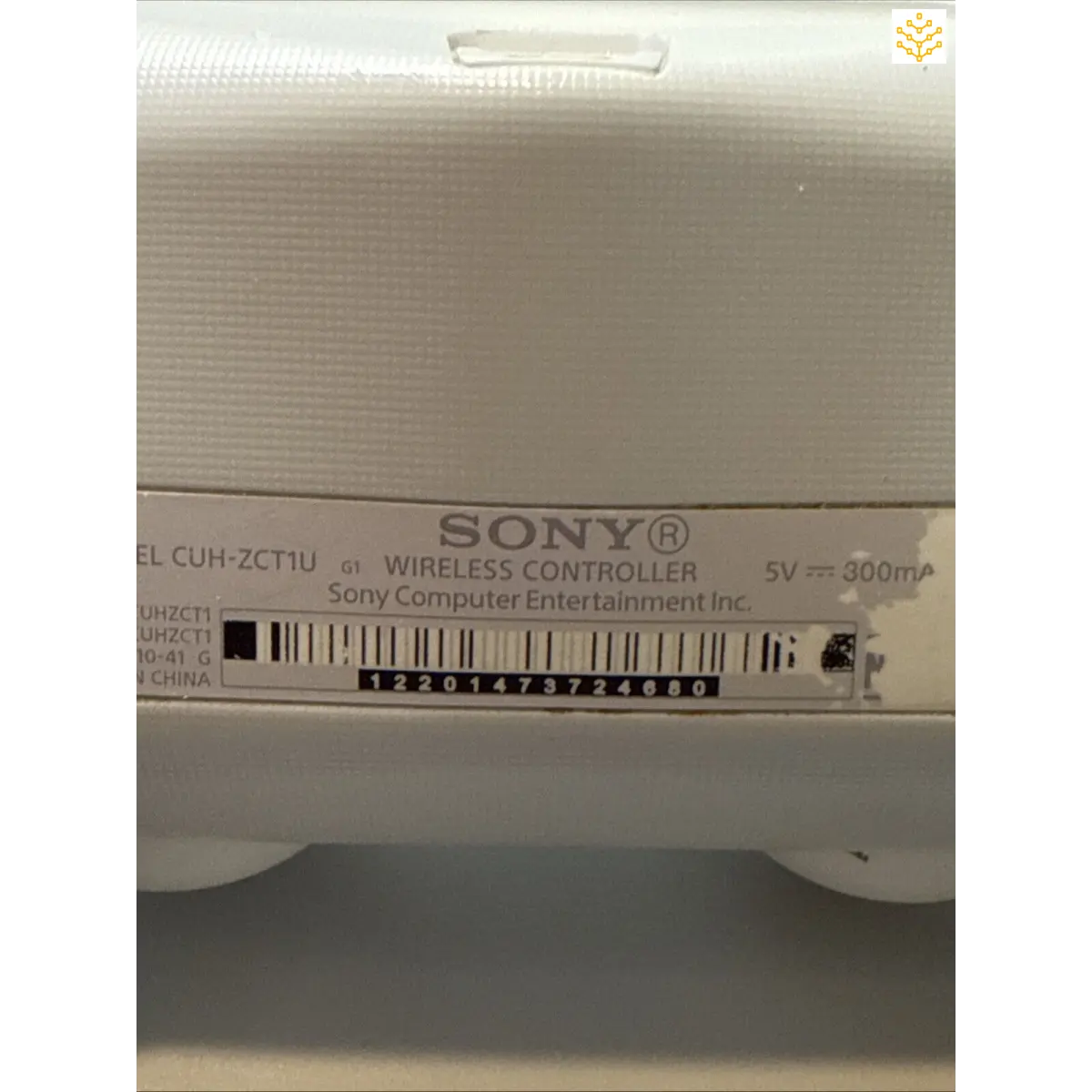 Sony wireless controller with product information label visible.