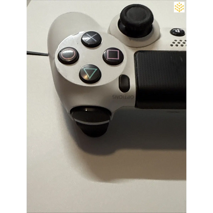 White PlayStation 4 controller with black buttons and joysticks.