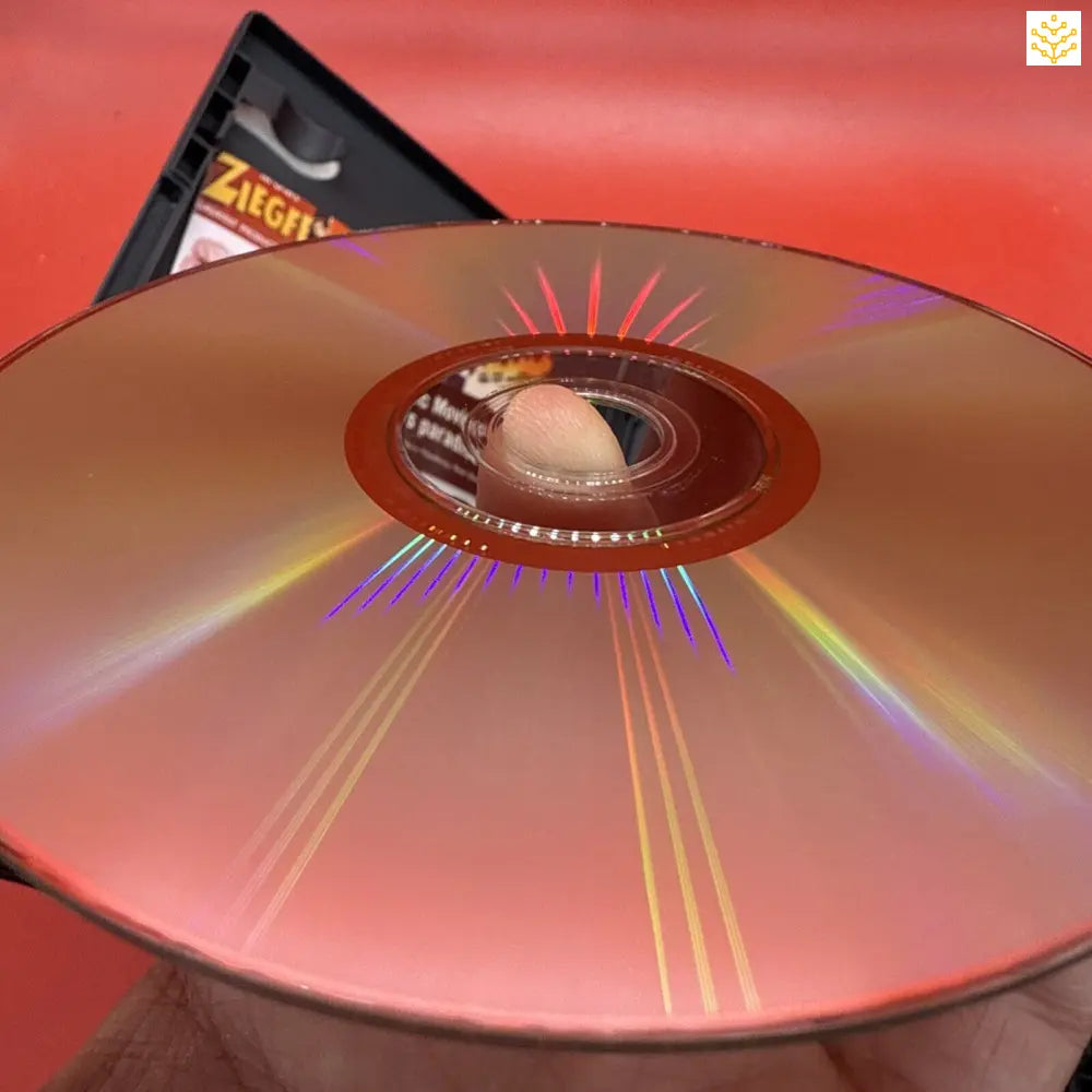 Shiny compact disc (CD) reflecting rainbow colors on its surface.