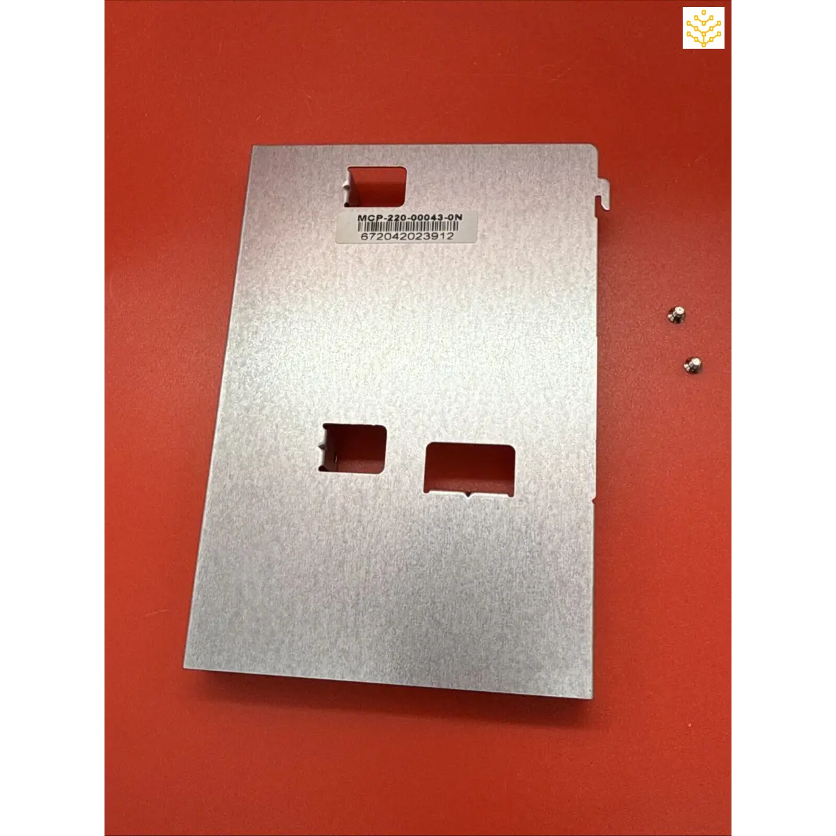 Metal plate or panel with rectangular cutouts and a printed barcode.