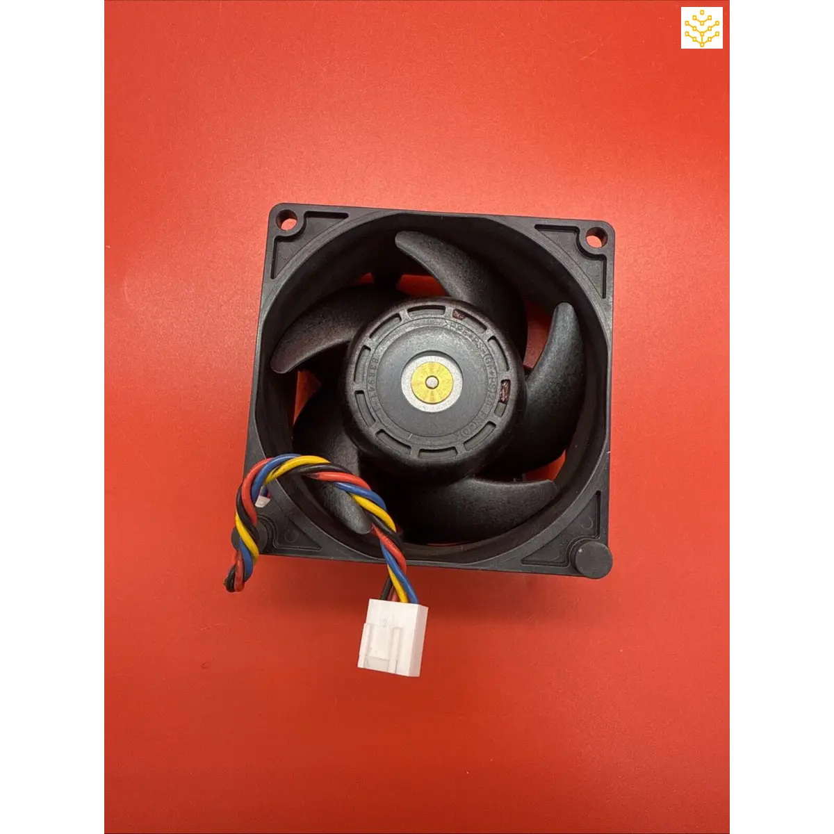 Computer cooling fan with black blades and a multicolored wire connector.