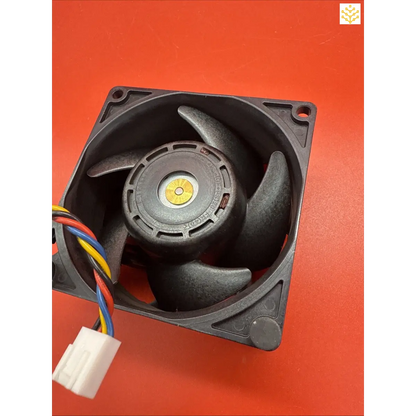 Computer cooling fan with black blades and multicolored wires.