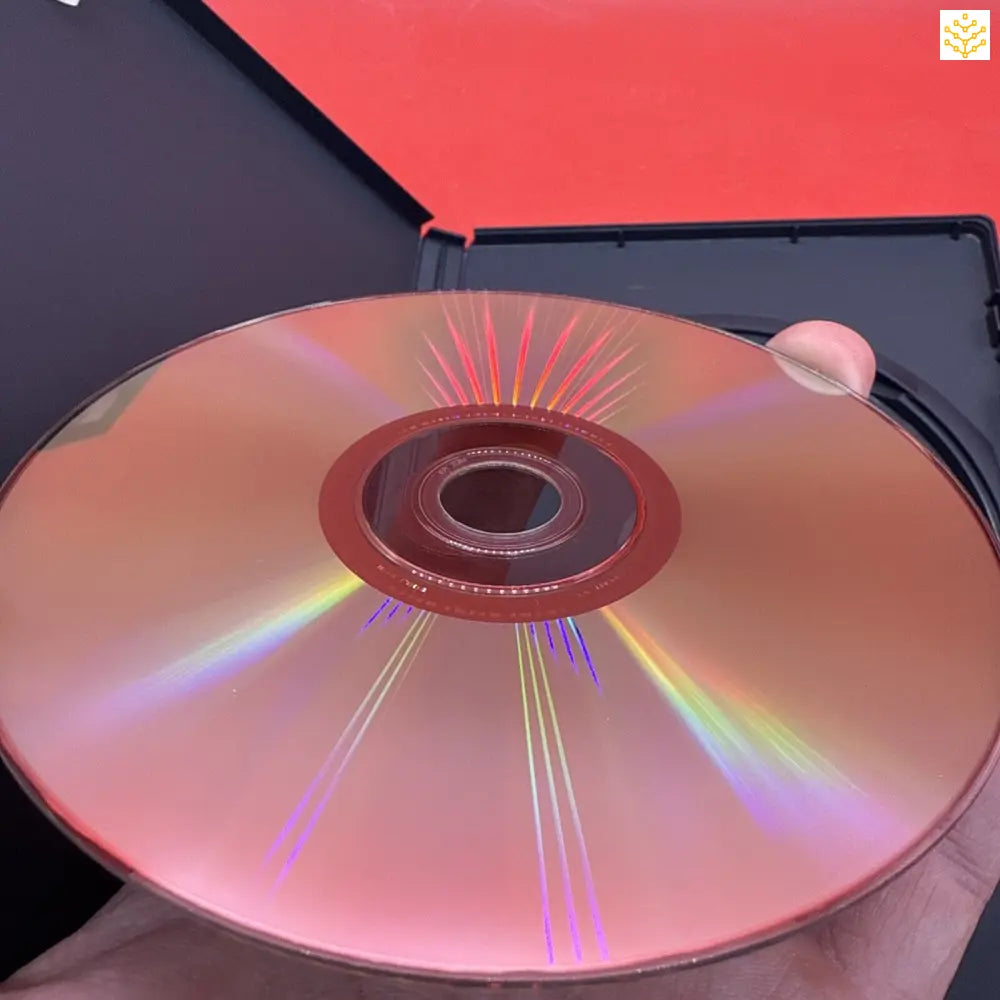 Compact disc (CD) displaying iridescent rainbow reflections across its surface.