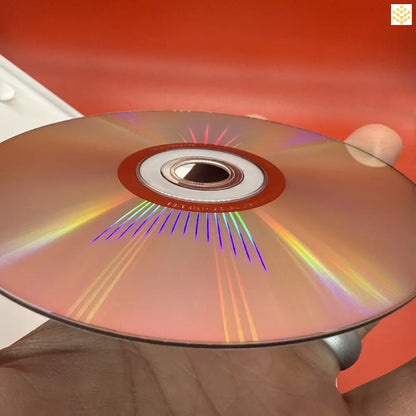 Compact disc (CD) reflecting rainbow colors across its metallic surface.