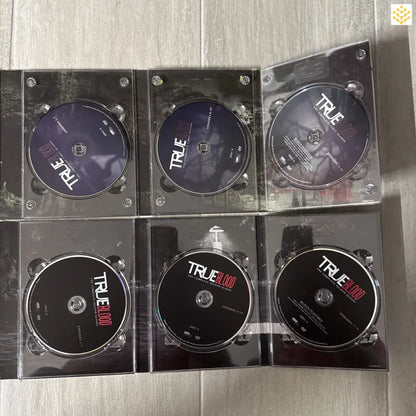 Collection of DVD discs from the TV series ’True Blood’ in clear plastic cases.