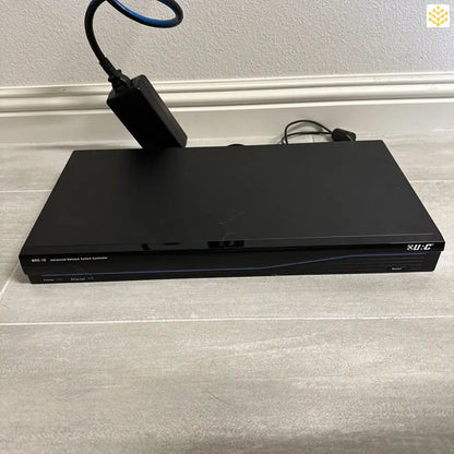 Black DVD or Blu-ray player with cables connected.