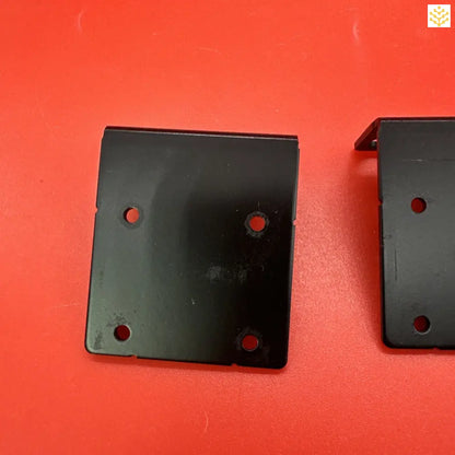 Black metal bracket or mounting plate with four holes.