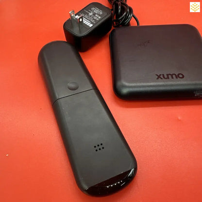 Elongated black electronic device resembling a remote control or streaming stick.