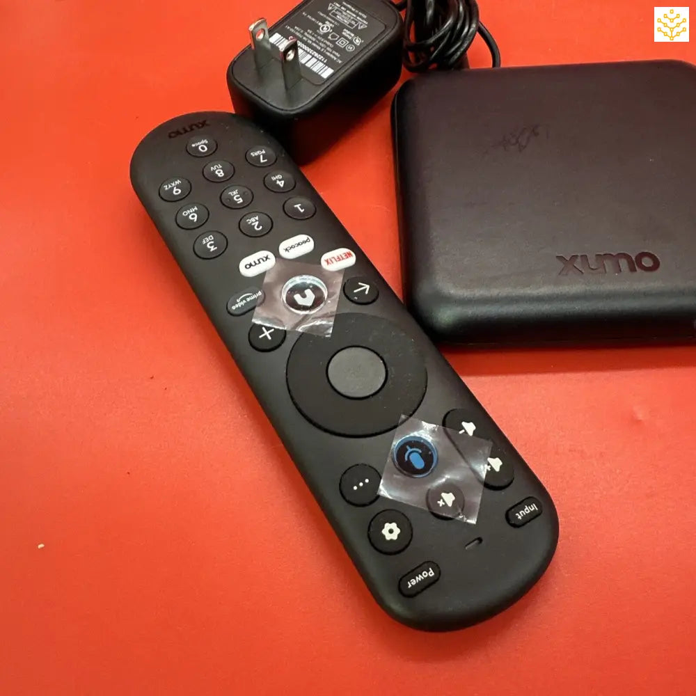 Remote control with numerous buttons and a circular navigation pad.