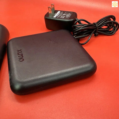 Portable external hard drive with its power adapter.